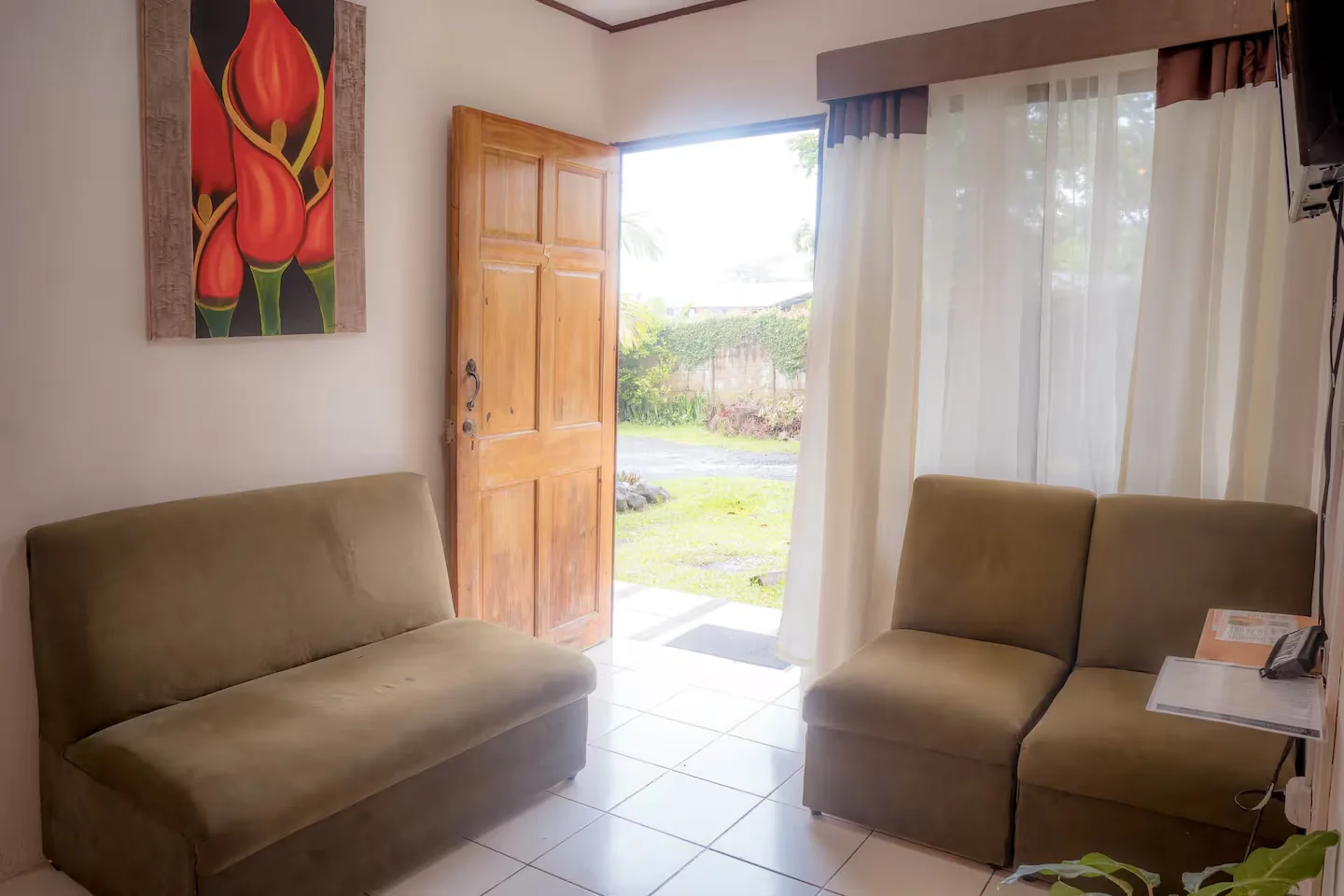 Living room with the front door open onto the grass outside