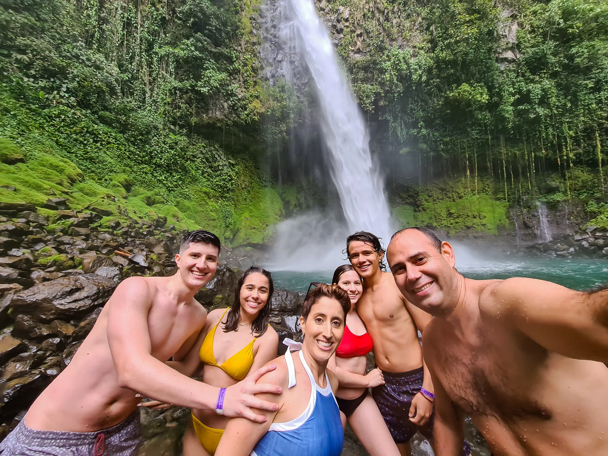 Travelers at the foot of the La Fortuna Waterfall