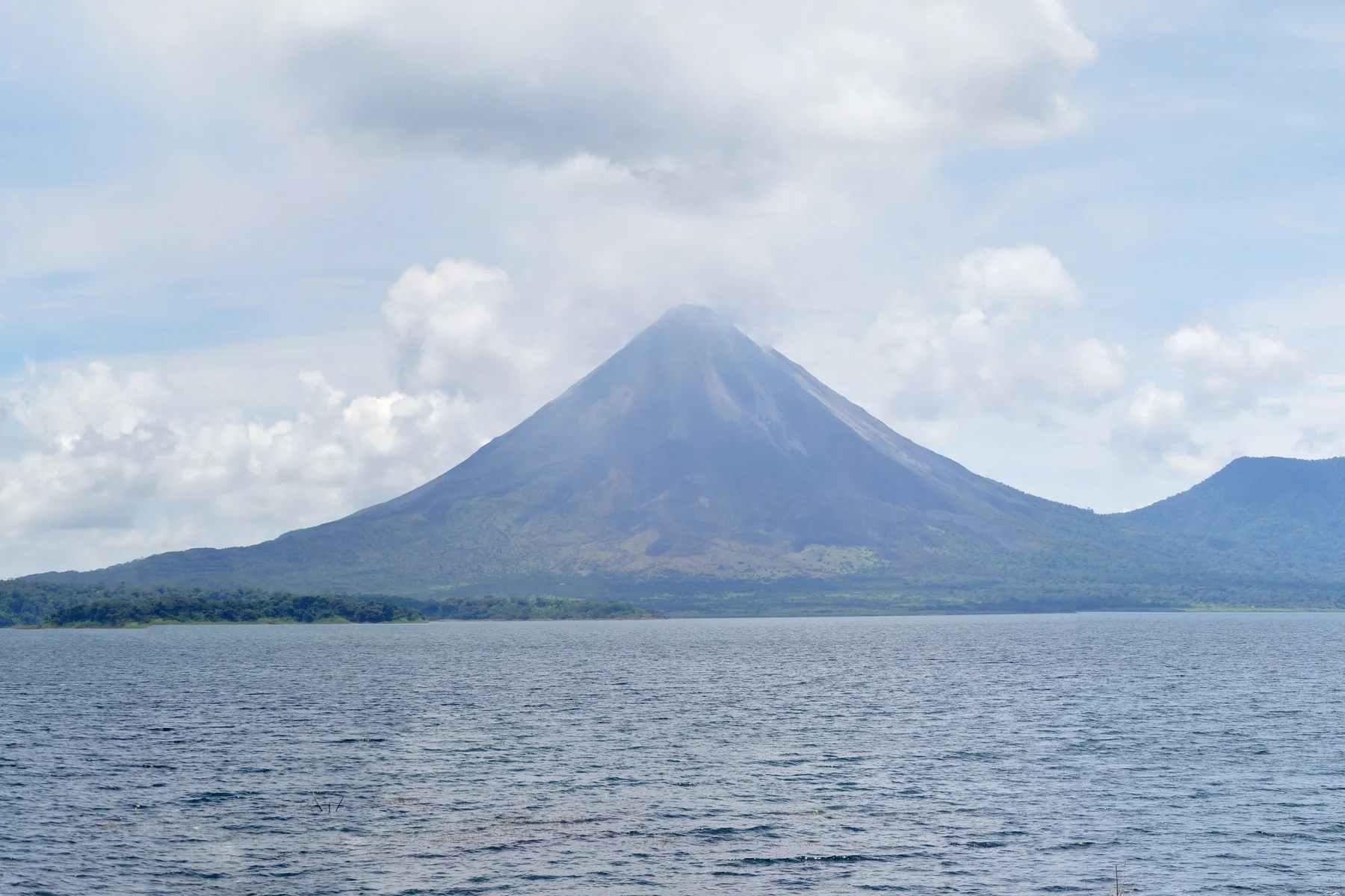 Lake Arenal with the volcano behind it, seen from the water