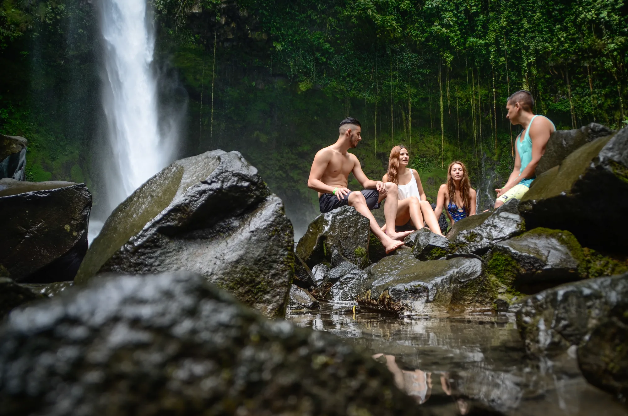 Sitting on the rocks below the waterfall