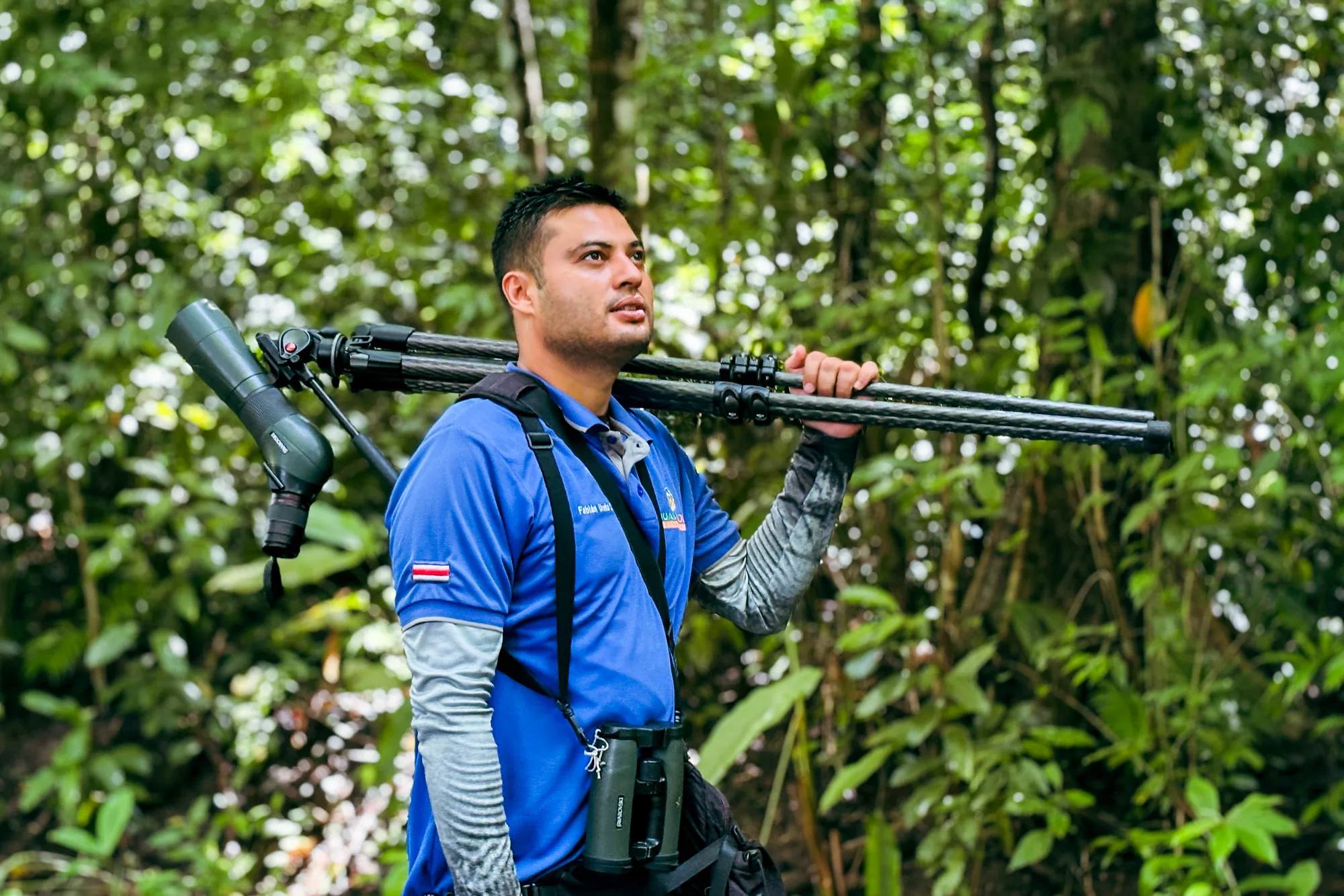 Guide carrying the spotting scope along the trail