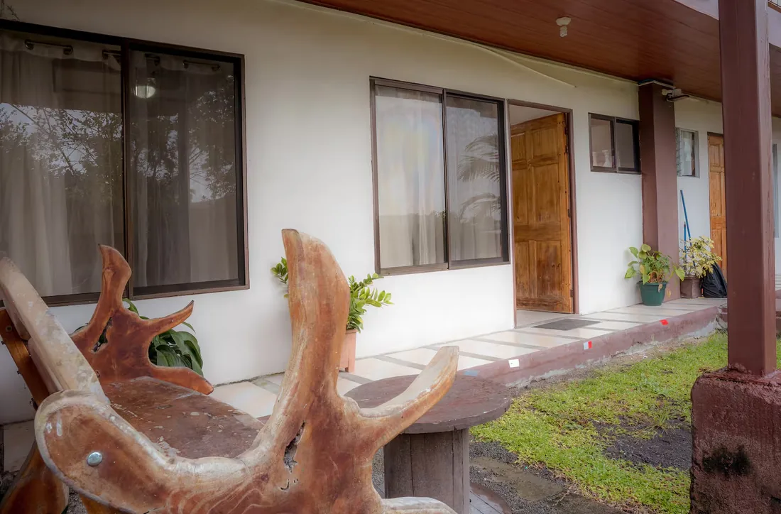 The covered walkway of the homes, with their wooden doors opening onto the garden